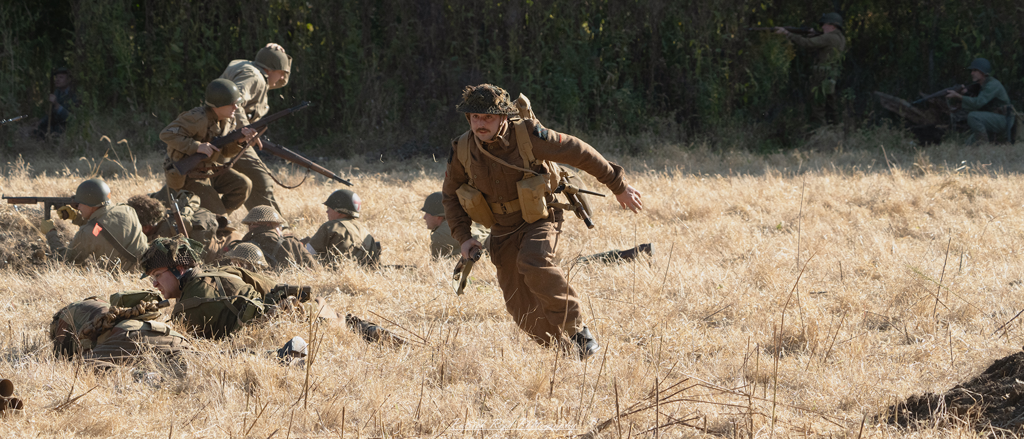"Action shot of a U.S. GI (Government Issue) running through a grassy field during WWII. The soldier is clad in standard military gear, including a helmet and combat uniform, with a focused expression that conveys determination and urgency. The background features a blurred landscape, emphasizing the soldier's movement and the intensity of the moment, capturing the spirit of bravery and resilience in the face of adversity."